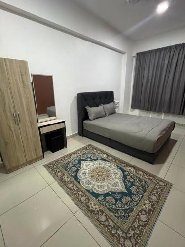 a bedroom with a bed and a rug at Ilsham Guest House @ Seroja Hills BBST Sepang in Sepang
