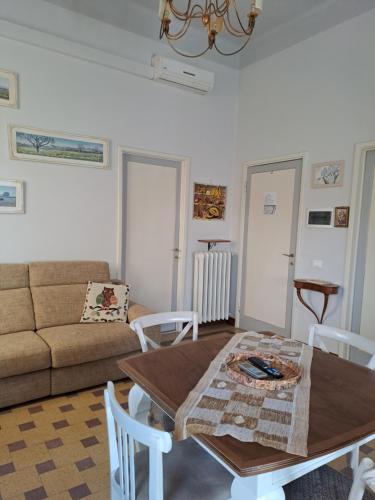 a living room with a table and a couch at Dimora Altemura in Lucca