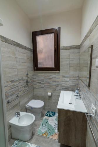 a bathroom with a toilet and a sink at Tampasio Apartment Trapani centro in Trapani