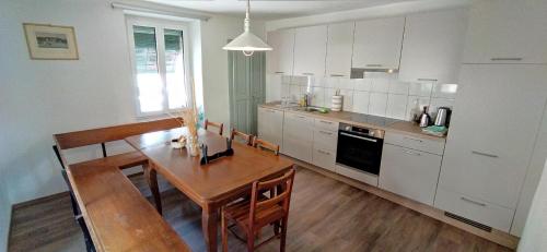 a kitchen with a wooden table and a dining room at Cò d'Franz - 1P in Ponto Valentino