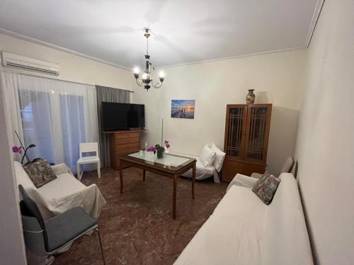a living room with a couch and a table and a tv at Billy's appartment in Preveza