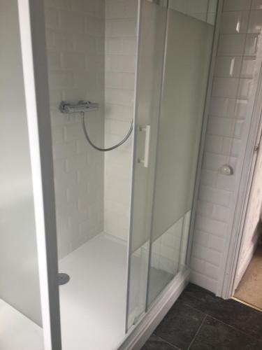 a shower with a glass door in a bathroom at Minook in Thorney