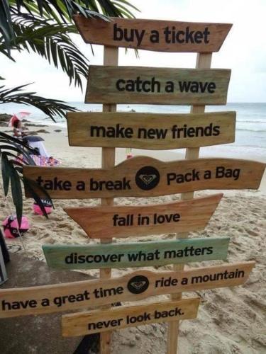 a wooden sign on the beach with many signs at Malabata Hills Retreat in Tangier