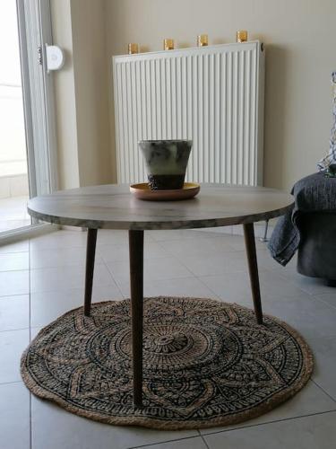 a table with a vase sitting on top of it at Nest by the Sea in Perea