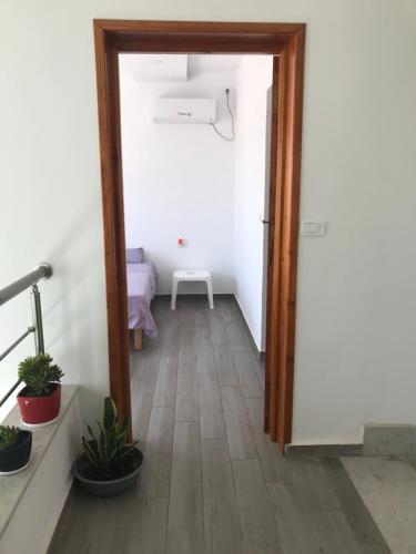 a hallway with a door leading into a room at Villa privé 4 chambres 4 lit double à Djerba en face de la ferme de lotos in Midoun