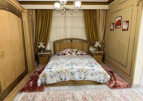 a bedroom with a bed and two night stands at Luxury Apartment 2 Nasr City- City stars in Cairo