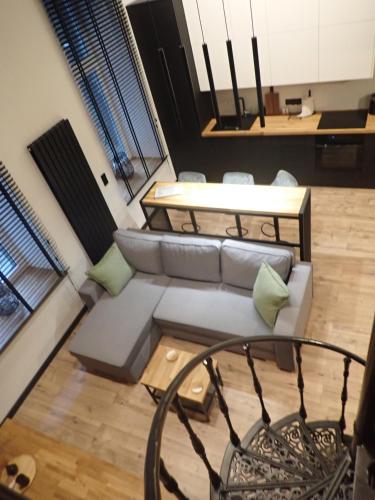 a living room with a couch and a table at Apartament Narutowicza 56 in Łódź