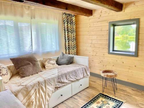 a bedroom with a bed in a wooden wall at Country House in Vadul lui Carol II