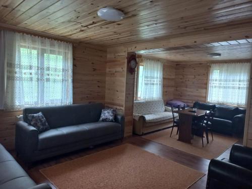 a living room with a couch and a table at Saklı Bahçe Suite in Uzungöl