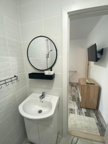 a white bathroom with a sink and a mirror at Villa Sea House 3 in Byala