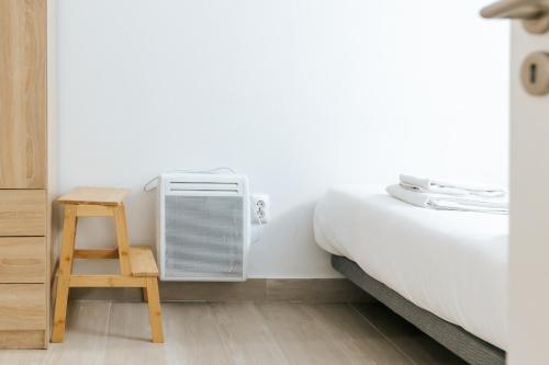 a bedroom with a bed and an air conditioner at Arroios Nice Flat in Lisbon