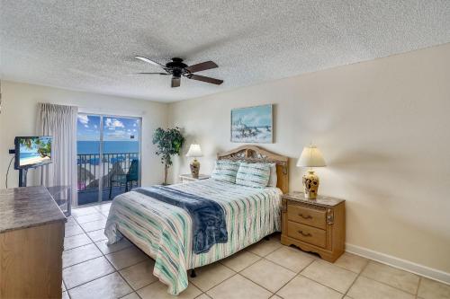 a bedroom with a bed and a view of the ocean at Sand Dollar 107 in Clearwater Beach