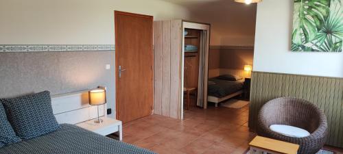 a room with a bed and a chair and a bedroom at B&B Auberge Verdon in La Palud sur Verdon