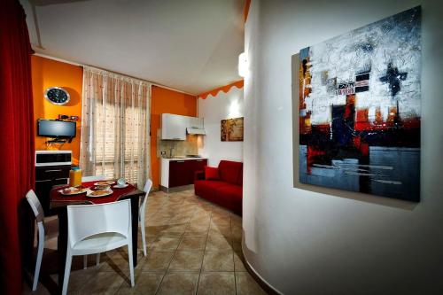 a living room with a table and a red couch at Residence Mareluna in Castellammare del Golfo