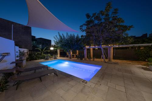 a swimming pool in the backyard of a house at B&B Palazzo la Traja in Gagliano del Capo
