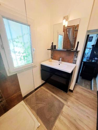 a bathroom with a sink and a glass shower at Studio Centre Ville Stadium in Agen