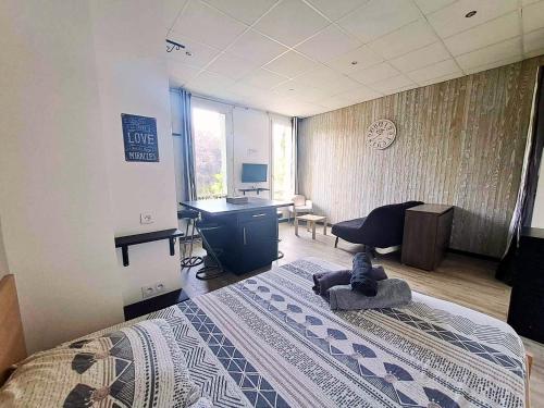 a bedroom with a bed and a desk and a computer at Studio Centre Ville Stadium in Agen