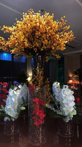 a group of vases filled with flowers on a table at Jiwar Almasi Hotel in Jeddah