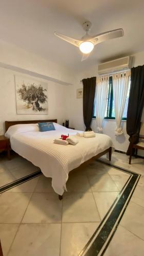 a large bed in a bedroom with a ceiling at Villa eco Electra in Nikiti