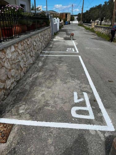 a street with a handicapped parking lot with a fire hydrant at BIO Garden Stonehouse in Gonia
