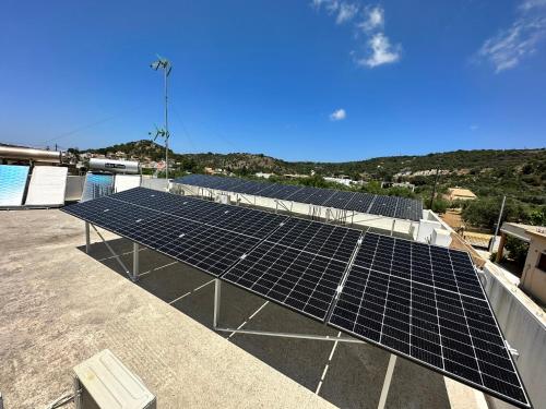 a group of solar panels on top of a roof at BIO Garden Stonehouse in Gonia