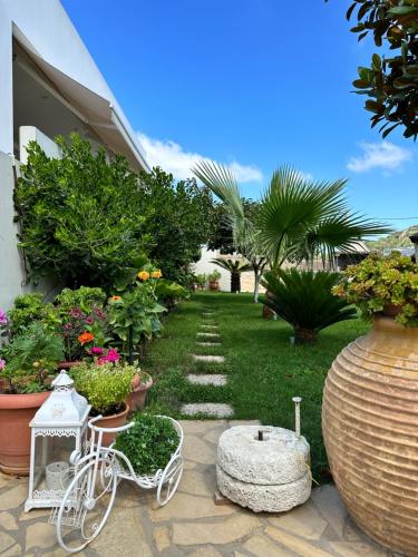 a garden with a white bike and some plants at BIO Garden Stonehouse in Gonia