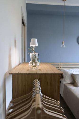 a table with a lamp on it in a bedroom at Sunrise Sardinia Posada in Posada