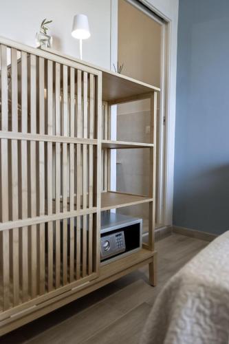 a bedroom with a book shelf with a radio at Sunrise Sardinia Posada in Posada