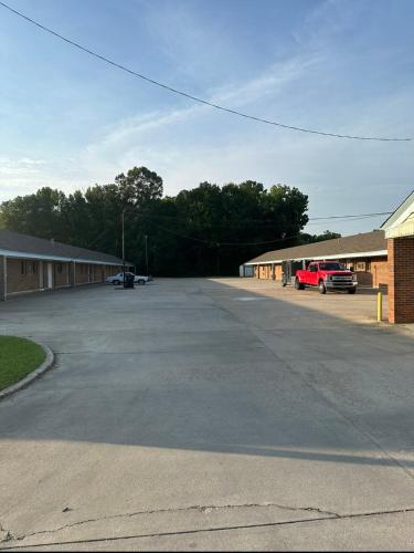 an empty parking lot in front of a building at Travel Inn Montgomery AL in Montgomery