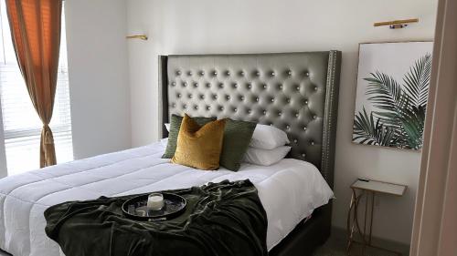 a bedroom with a large bed with a black headboard at The Refuge Retreat in Fort Worth