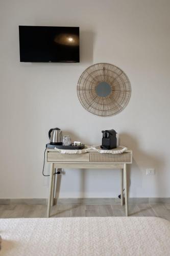 a white table with a mirror on a wall at Sunrise Sardinia Posada in Posada