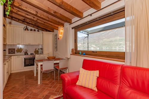 a living room with a red couch and a table at Villetta la Colombaia in Carzano
