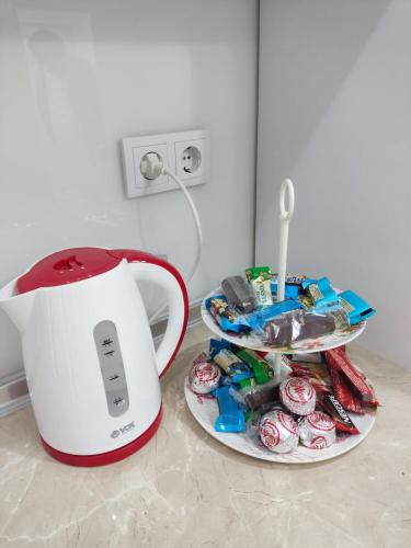 a counter with a mixer and a plate of cupcakes at Apartman Kasic in Konjic