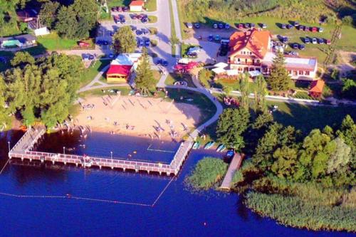 an aerial view of a resort on the water at Klimatyczne mieszkanie w krainie jezior in Biskupiec