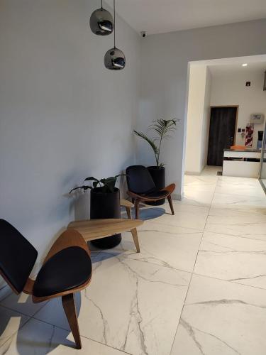 a room with chairs and a table and plants at Temporario catamarca in San Fernando del Valle de Catamarca