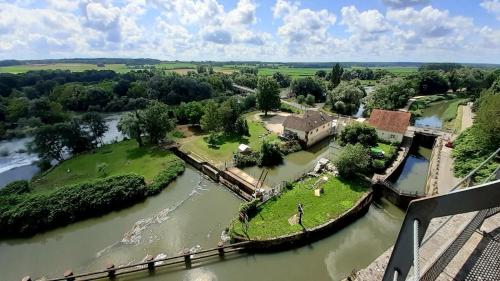 an aerial view of an island in a river at La roulotte de moulin rouge in Audelange