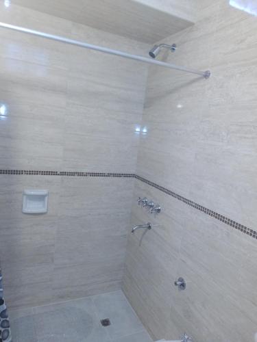 a bathroom with a large shower with a shower at Departamento sierras Balcarce in Balcarce