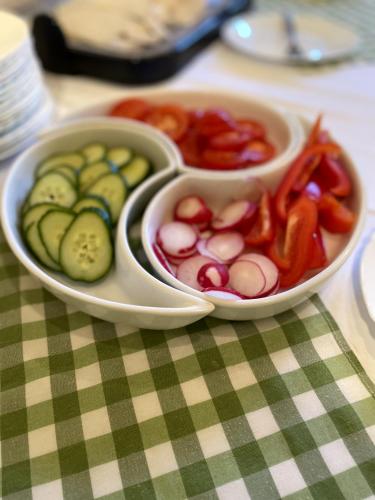 a tray of pickles and other vegetables on a table at Eichenhof Hotel Garni in Groß Köris