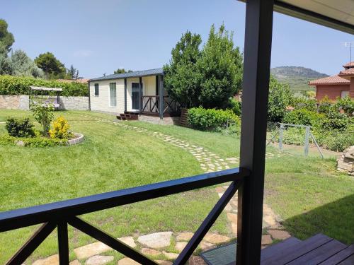 a view of a yard from a window at Naturalayos I y Naturalayos II - casas para parejas - jacuzzi in Pelayos de la Presa