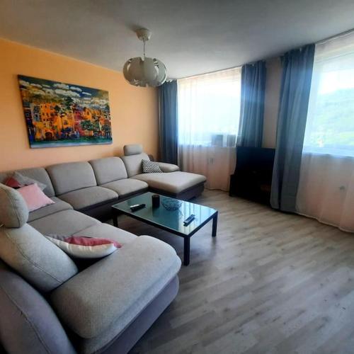 a living room with a couch and a coffee table at "House of swallows" vacation home, close to Sofia in Makotsevo