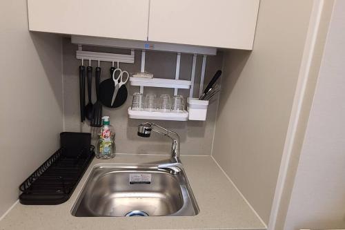 a kitchen counter with a sink in a kitchen at Elbon The beach Haeundae in Busan