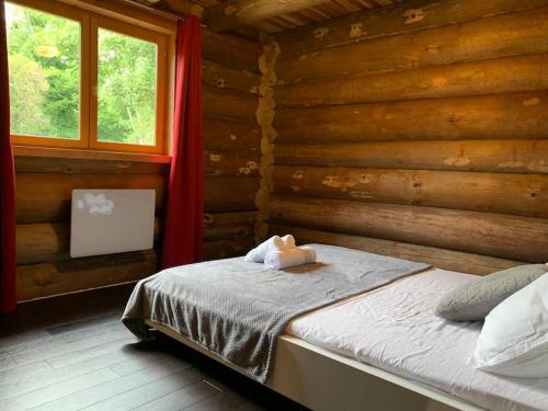 a bedroom with a bed in a log cabin at Hébergement d'exception à Zonza in Zonza