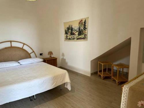 a bedroom with a large bed and a staircase at LaMarticata-LikesHome Garden in Triscina