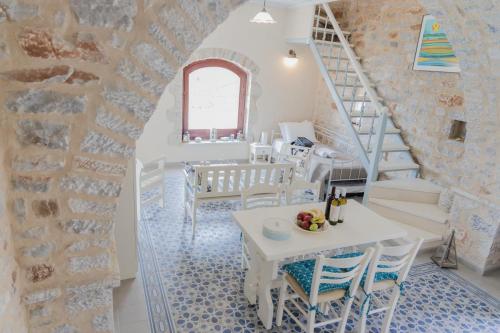 a staircase in a room with a table and chairs at Ampelos Tower in Kokkala