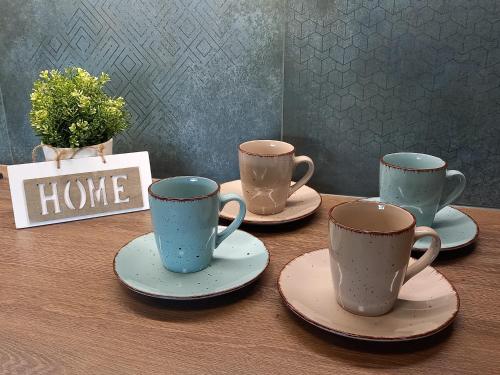 four coffee cups and saucers on a table at Penzion Pod Sudem in Lázně Libverda