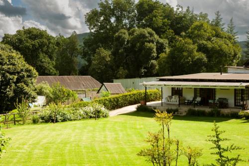 a house with a large lawn in front of it at Newstead Farm - Country Cottages in Curryʼs Post