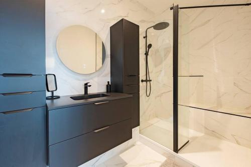 a bathroom with a shower and a sink and a mirror at Grammont 5 - Appartement luxueux à Tours in Tours