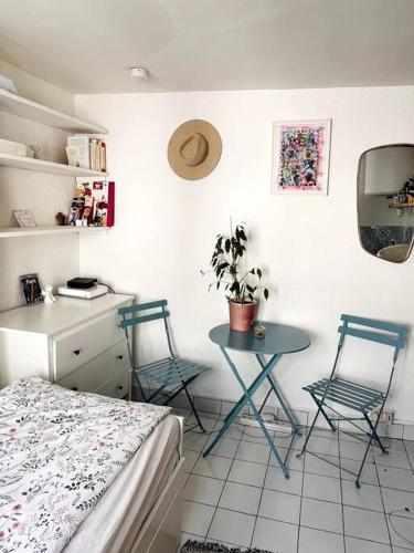 a room with a bed and a table and chairs at Cute Marais Private Studio for 2 in Paris