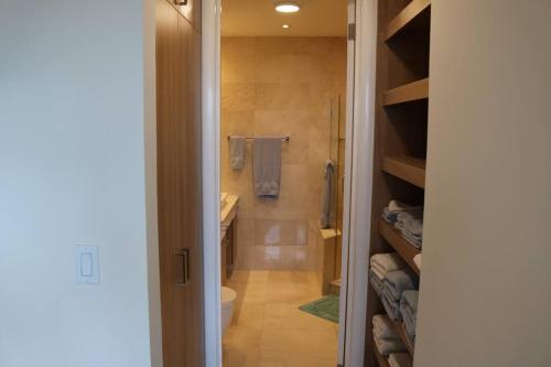a bathroom with a toilet and a walk in shower at 08B Luxury Oceanfront Resort Lifestyle Panama in ArraijÃ¡n
