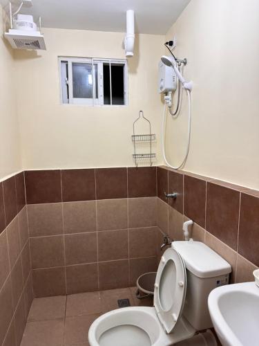 a bathroom with a toilet and a shower at Arezzo Condo Staycation in Davao City